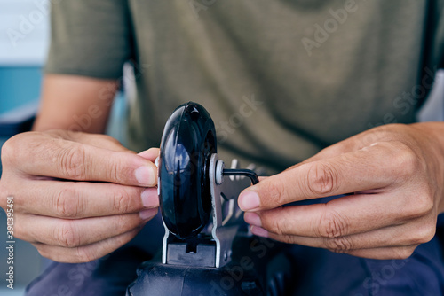 man changing the wheels of an inline skate