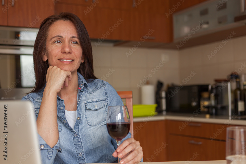 Happy woman drinking wine and day dreaming at home. Happy woman drinking wine and day dreaming at home.