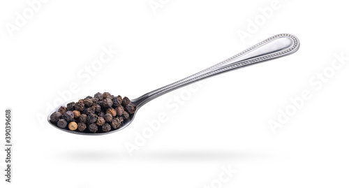 black pepper in steel spoon on a white background