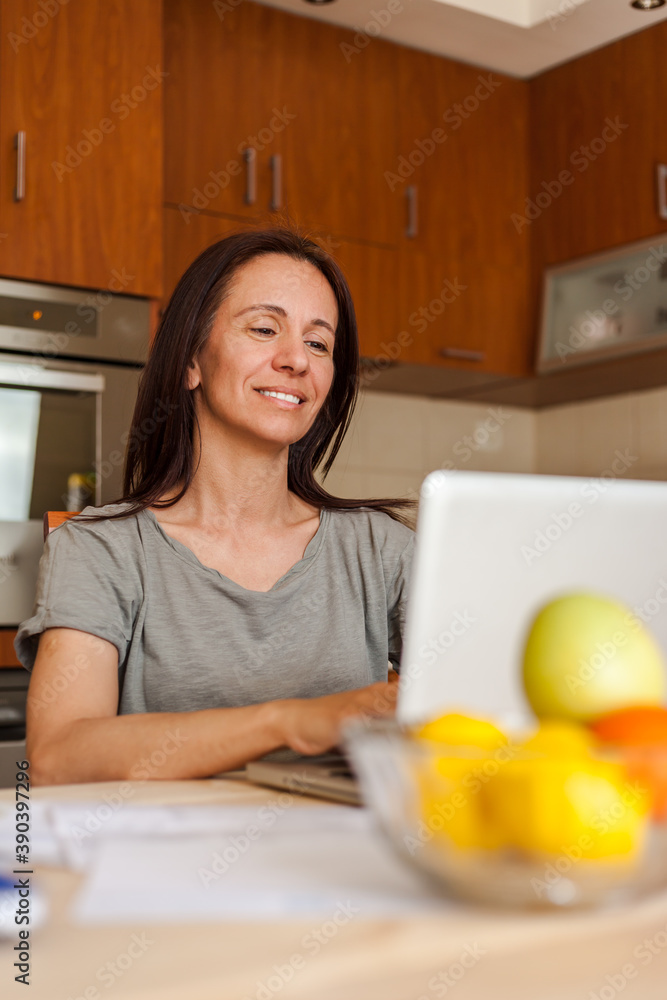 Happywoman reading an e-mail on a computer at home. Happywoman reading an e-mail on a computer at home.