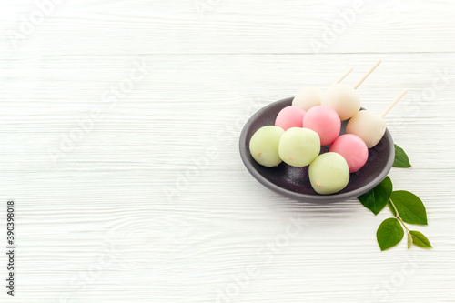 Japanese Dango dessert in pink, white and green colors, copy space