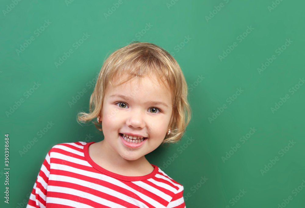 Caucasian child portrait on green empty space background.Kid with chalkboard backdrop. Caucasian child portrait on green empty space background.Kid with chalkboard backdrop.