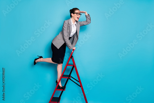 Full length profile side photo girl marketer climb career ladder hand eyes watch wear blazer jacket skirt isolated blue color background