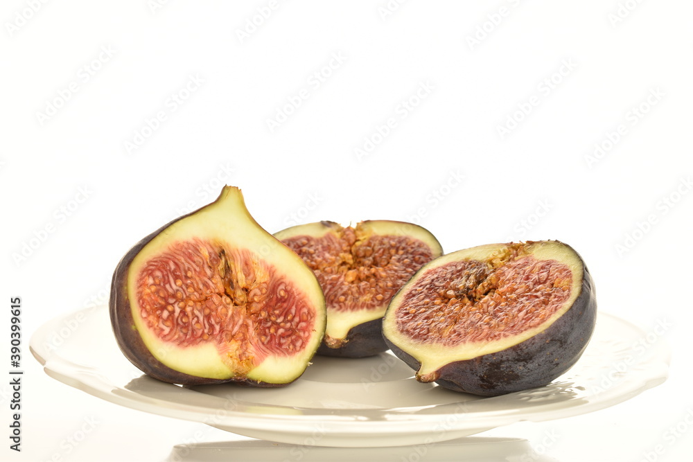 Ripe dark blue organic figs, close-up, on a white background.