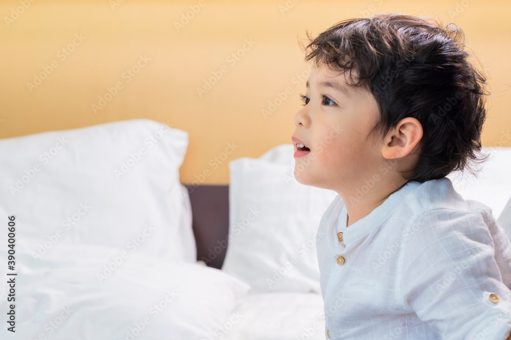Cute Asian child looking away at copy space with smiling face, Candid shot Cute little boy relaxing stay at home. Childhood, Power, Strength Concept Cute Asian child looking away at copy space with smiling face, Candid shot Cute little boy relaxing stay at home. Childhood, Power, Strength Concept