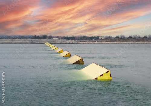 The MOSE System in Venice, Italy at the sunset for defense against high waters. Barrier against the high water in the defense of Venice Lagoon. New generation of industrial flood prevention system.