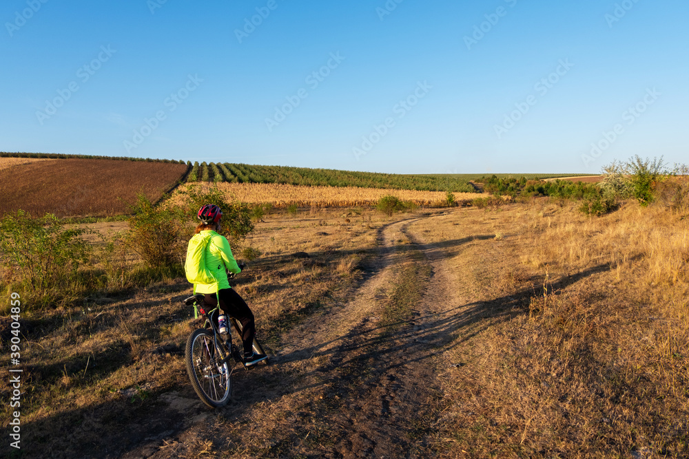 A woman cyclist on a country road in Moldova