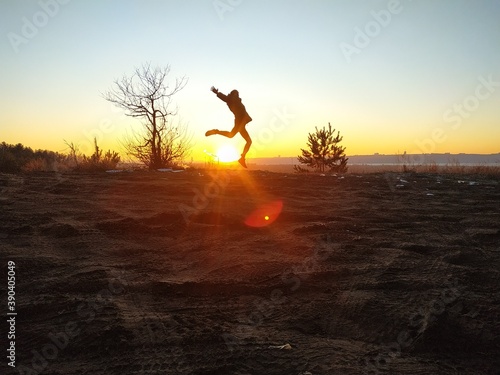 silhouette of a man jumping at sunset