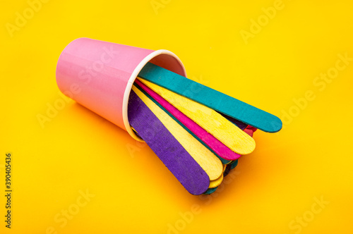 Colorful ice cream sticks coming out of cup - abstract background