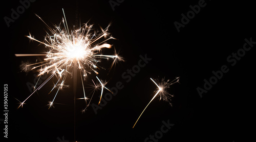 Burning sparkler on a black background with place for text. New year  birthday