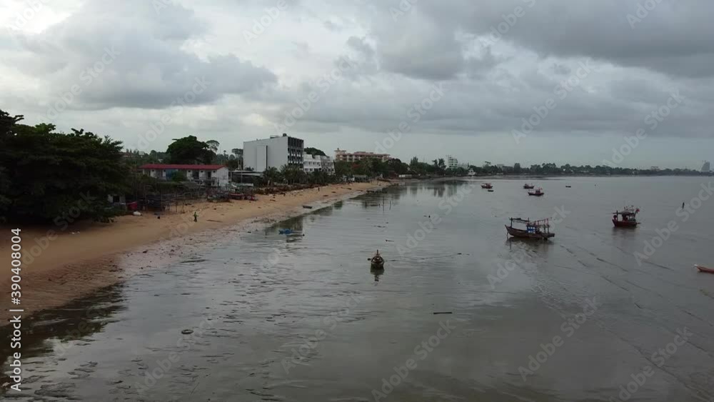 Low over Thai fishing boats stormy morning low tide reflected sky Low over Thai fishing boats stormy morning low tide reflected sky