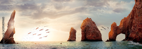 Rocky formations on a sunset background. Famous arches of Los Cabos. Mexico. Baja California Sur. Panoramic image. Banner format.