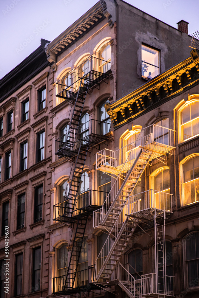New York City apartment buildings in the evening with lights New York City apartment buildings in the evening with lights