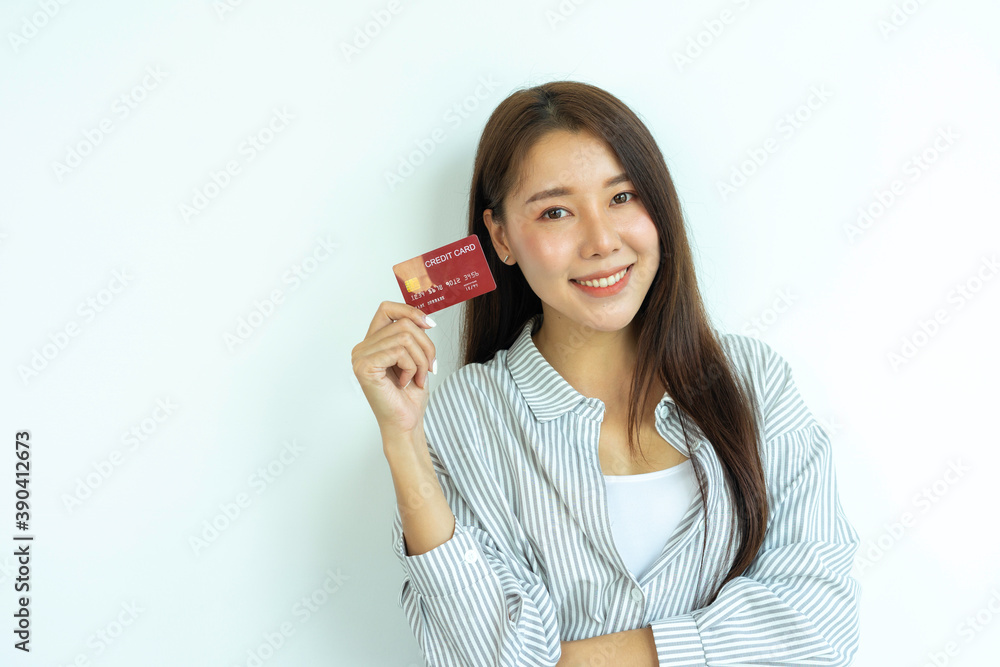 A beautiful smiling Asian woman holding a credit card. Lifestyle of the new generation Credit Card Spending Payment Confidence, Credit Card Spending Safety Concept A beautiful smiling Asian woman holding a credit card. Lifestyle of the new generation Credit Card Spending Payment Confidence, Credit Card Spending Safety Concept