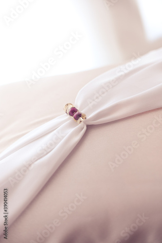 Pink silk pillowcase with pink beads in daylight. Love Story and Wedding mood. Can used like background.