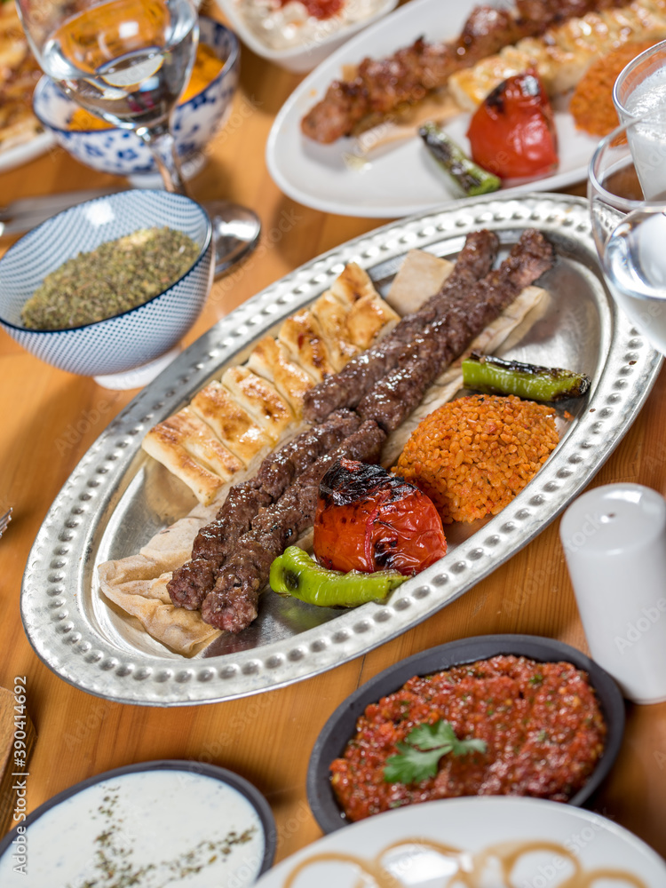 shish meatball kebab from turkish cuisine. served with white plate on wooden table. shish meatball kebab from turkish cuisine. served with white plate on wooden table.