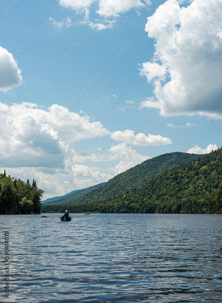 rowboat on a lake in the adirondack mountains