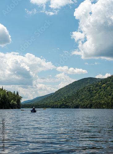 rowboat on a lake in the adirondack mountains