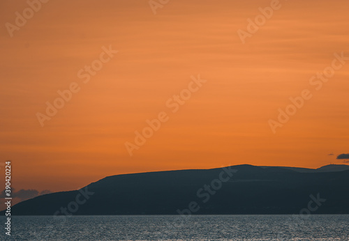 Beautiful sunset on Adriatic Sea coast in Croatia.Popular travel destination for active tourism in summer season.Beautiful Croatian seaside at dusk.Sun goes down over horizon in Europe