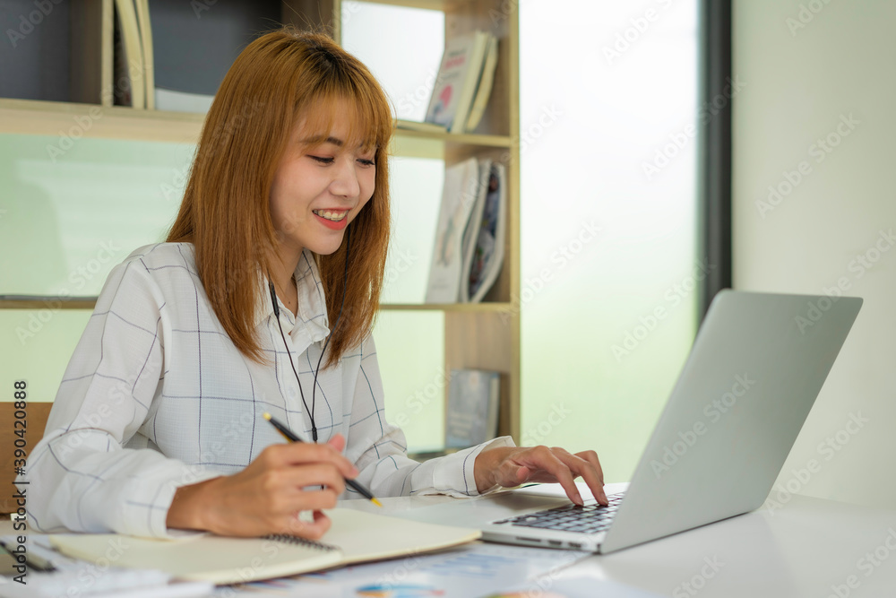 Business women are doing a webinar with their colleagues and are taking notes of statistics and results from online meetings, ideas through webinar online. Business women are doing a webinar with their colleagues and are taking notes of statistics and results from online meetings, ideas through webinar online.