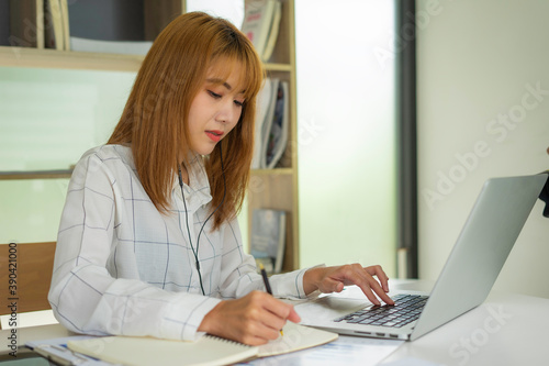 Business women keep records of statistics and company profits In the office to prepare for tomorrow morning meetings, business ideas and note-taking.