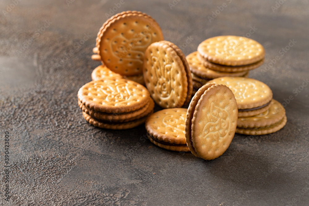 Sandwich biscuits cookies with chocolate filling on dark background. Crackers with cream Sandwich biscuits cookies with chocolate filling on dark background. Crackers with cream