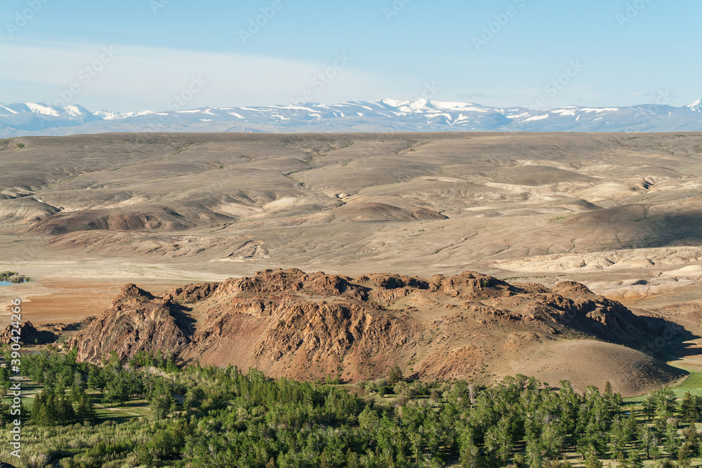 Hills and rocks of the Chuya steppe, in the light of the setting sun.