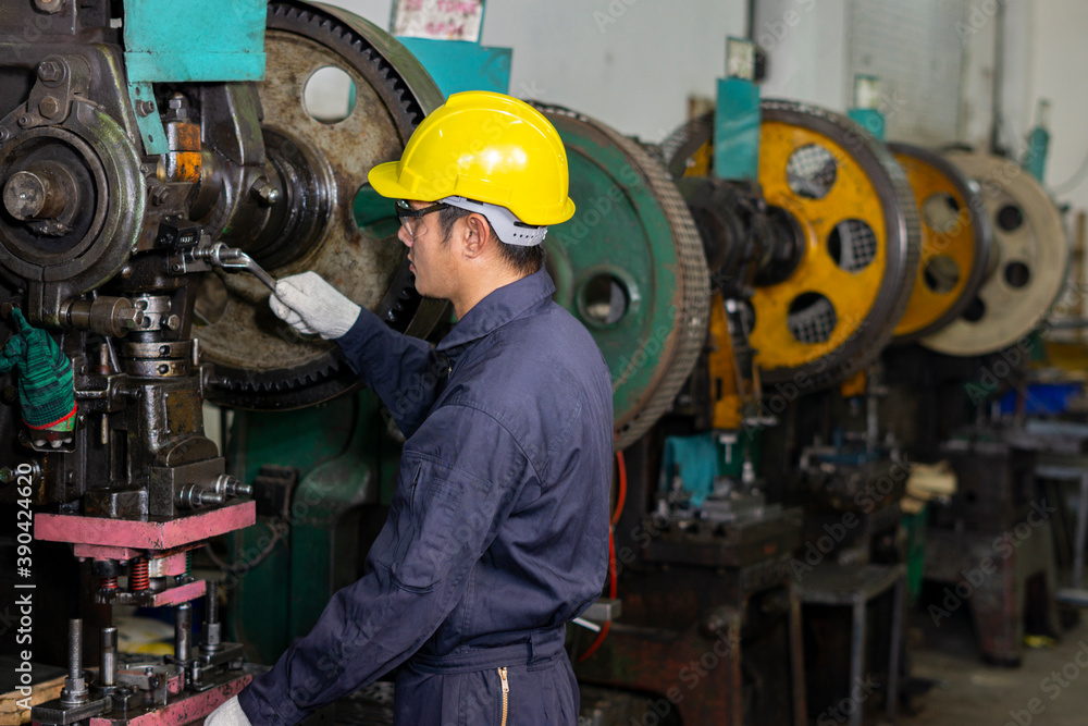 Technician in factory at machine maintenance working with wrench. Technician in factory at machine maintenance working with wrench.