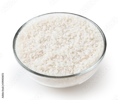 Uncooked round rice in glass bowl isolated on white background with clipping path