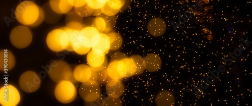 Sparkling golden Bokeh on a dark background.