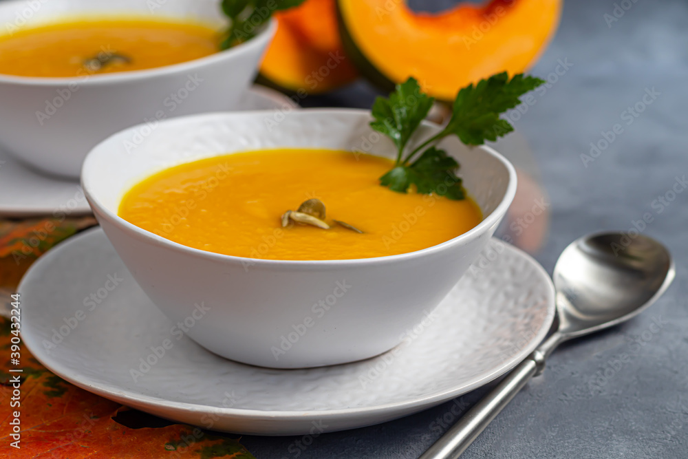 Fresh pumpkin cream soup with sour cream. Autumn lunch concept. A dietary, healthy dish. Fresh pumpkin cream soup with sour cream. Autumn lunch concept. A dietary, healthy dish.