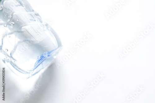 Close up photo of bottom of plactic bottle on white background © Wansa
