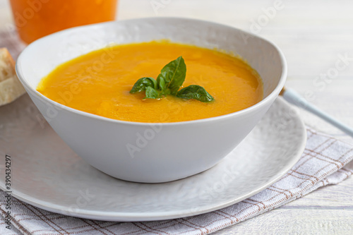 Fresh pumpkin cream soup with sour cream. Autumn lunch concept. A dietary, healthy dish.