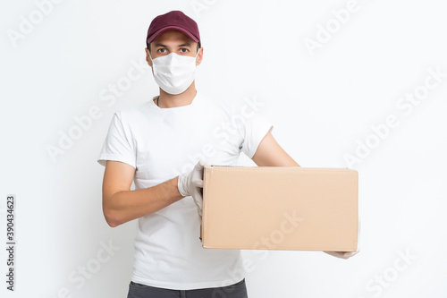 Delivery man holding cardboard boxes in medical rubber gloves and mask. copy space. Fast and free Delivery transport . Online shopping and Express delivery . Quarantine