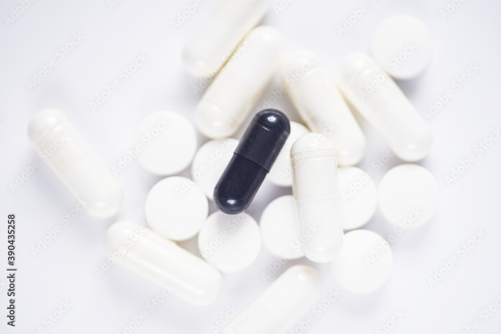Carbon capsules suround by white medicine on white background Carbon capsules suround by white medicine on white background