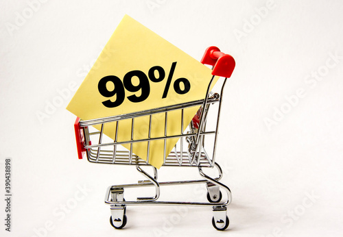 Shopping cart and text 99 percent on yellow paper note list. Shopping list, business concept on white background.