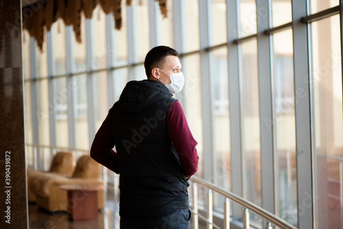 Sick man wearing a face mask in quarantine zone. New coronavirus (2019-nKoV) infection or Wuhan coronavirus