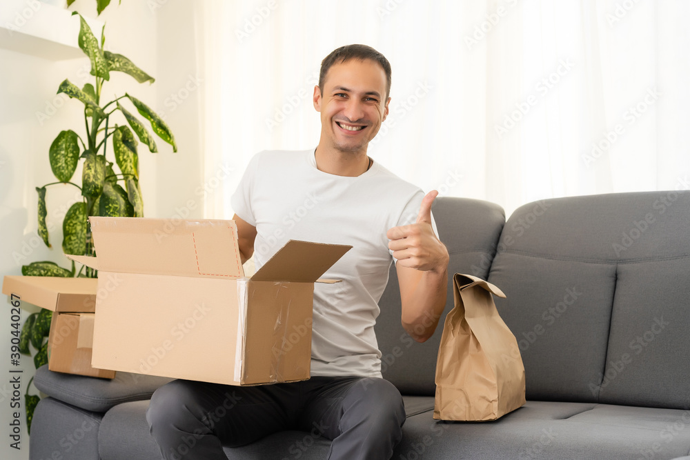 post, home and lifestyle concept - smiling man with cardboard boxes at home post, home and lifestyle concept - smiling man with cardboard boxes at home