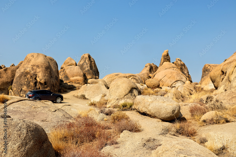 Rocky desert landscape with smooth boulders under a blue sky