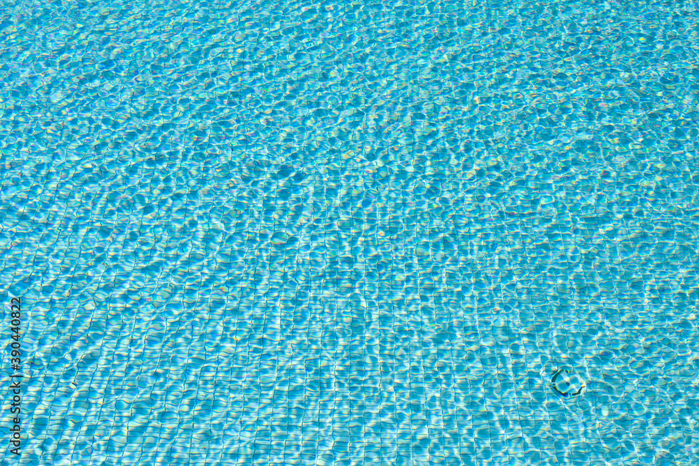 Surface of blue swimming pool,background of water in swimming pool. Ripple Water in swimming pool with sun reflection