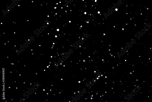 Falling white snow on the black background  snowflakes to overlay