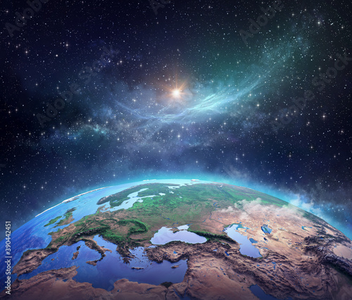 Fototapeta Naklejka Na Ścianę i Meble -  Surface of Planet Earth, space view of the World focused on Europe, galaxies, star cluster, nebula and the Sun shining far behind - Elements of this image furnished by NASA
