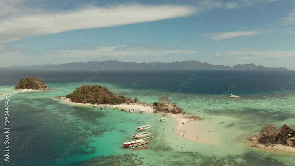 aerial seascape bay with tropical island and sand beach, turquoise water and coral reef. Bulog Dos, Philippines, Palawan. tourist boats on coast tropical island. aerial seascape bay with tropical island and sand beach, turquoise water and coral reef. Bulog Dos, Philippines, Palawan. tourist boats on coast tropical island.