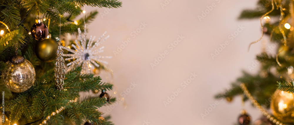 Golden Christmas background banner with a decorated Christmas tree and place for text