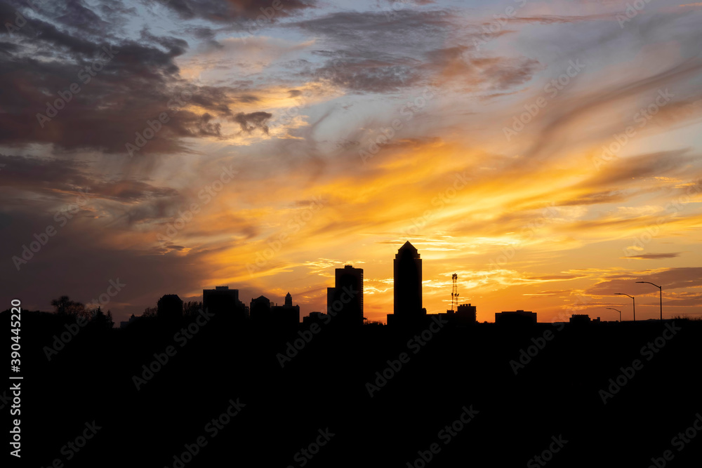The Des Moines skyline silhouetted against a gorgeous sunset with copy space.