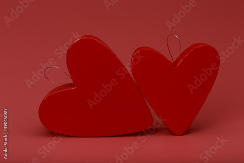 Two heart shape gift boxes on pink background photo