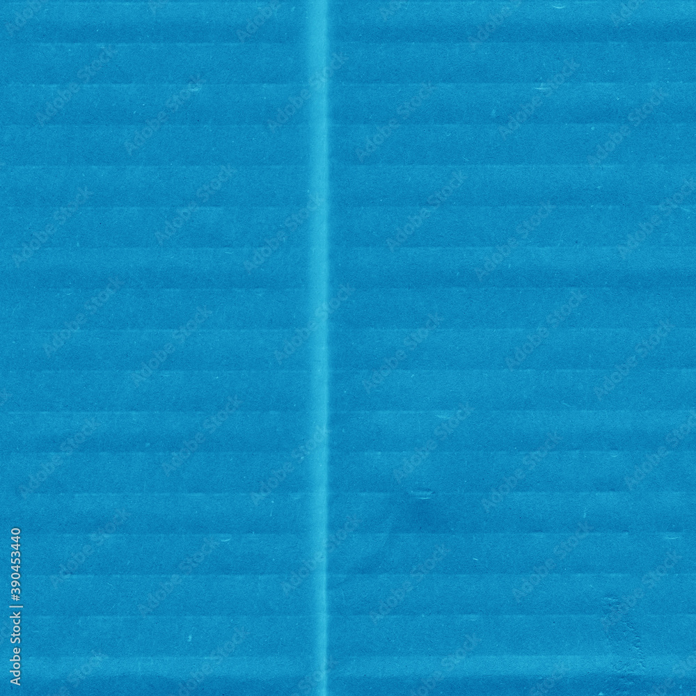 Fototapeta premium A blue vintage rough sheet of carton. Recycled environmentally friendly cardboard paper texture. Simple minimalist papercraft background.