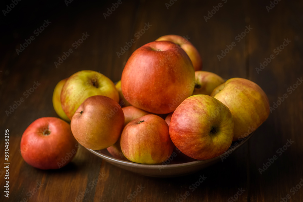 bowl full of apples on a wooden table bowl full of apples on a wooden table