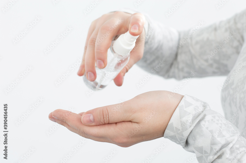 Close-up of a woman's hand being treated with an antiseptic. Coronavirus: treat your hands with an antiseptic against germs and viruses during a pandemic.