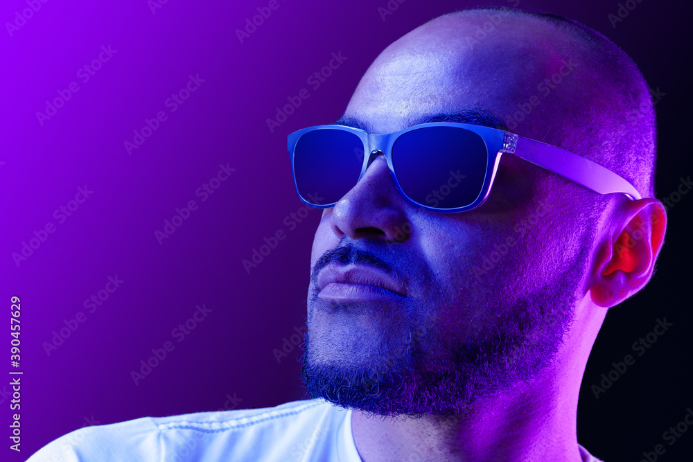 Portrait of afro american man model in glasses in neon light Portrait of afro american man model in glasses in neon light